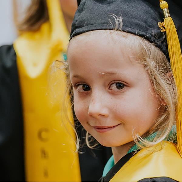 Child dressed in university robes.
