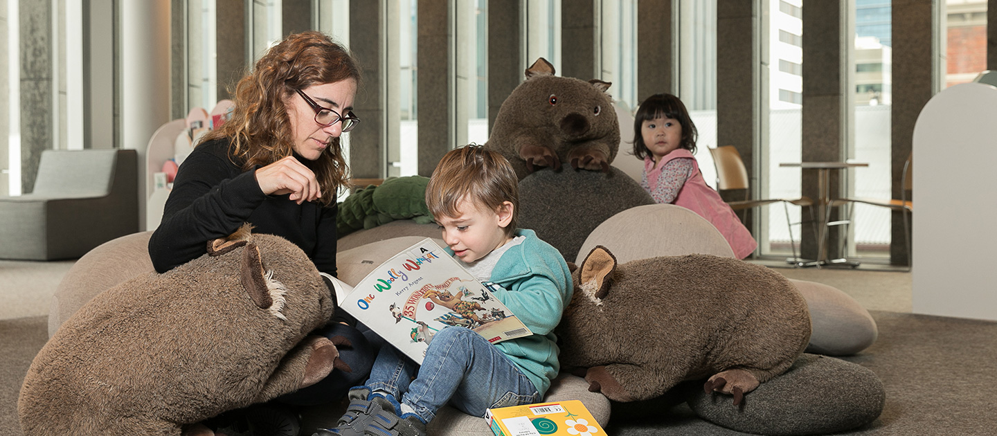 Mother and toddler reading book