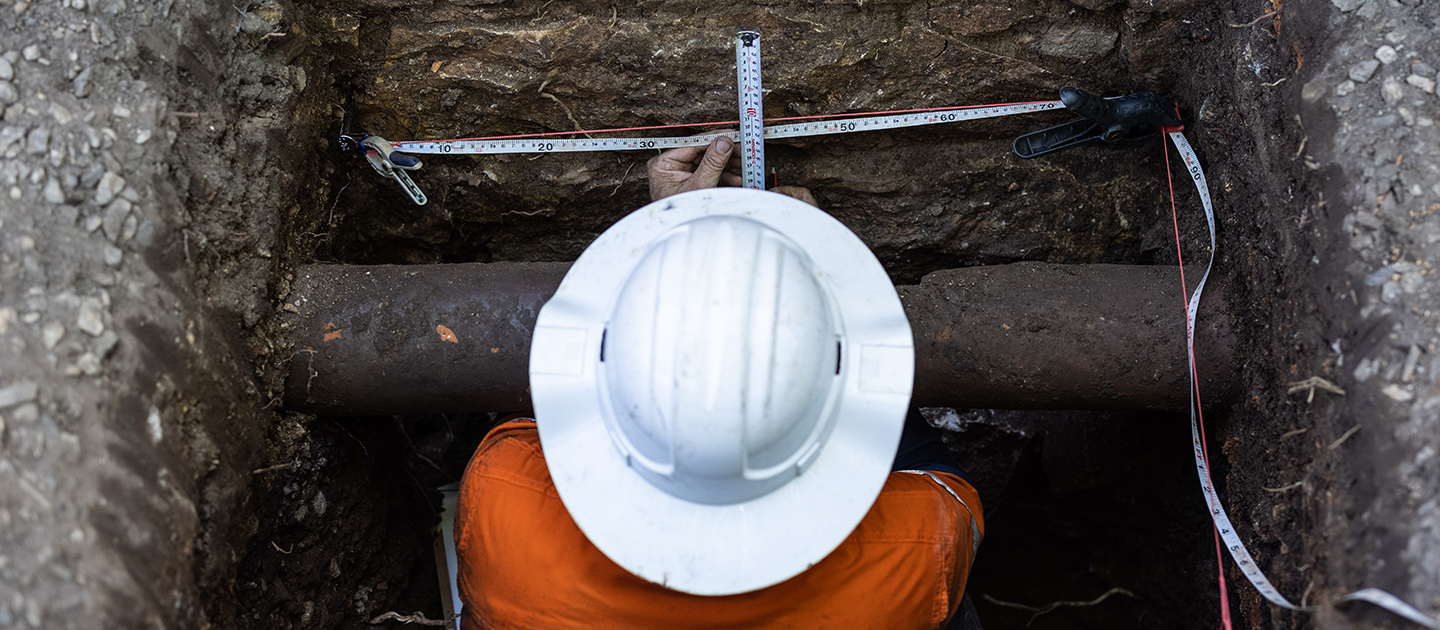 Everick Heritage archaeologist measuring an excavation.  