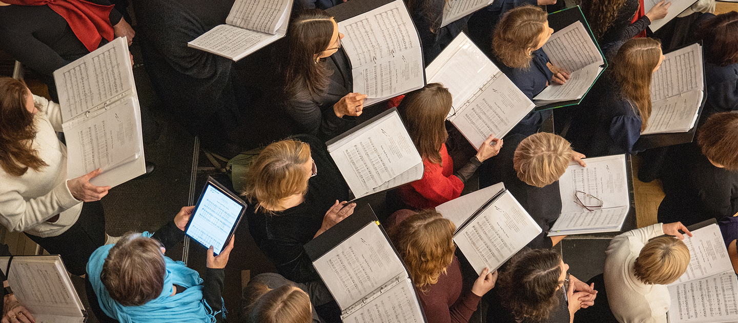 View of choir holding sheet music from above. 
