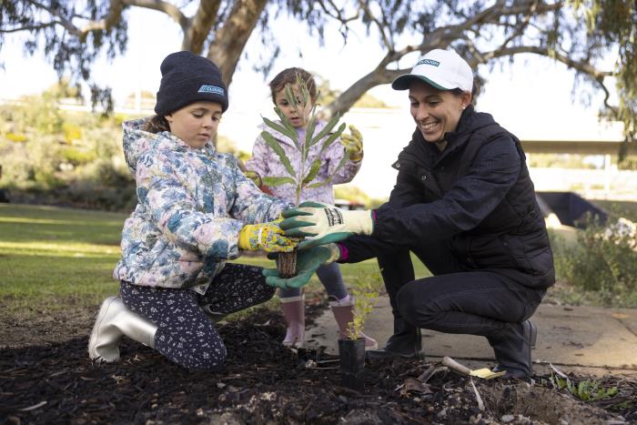 family planting trees