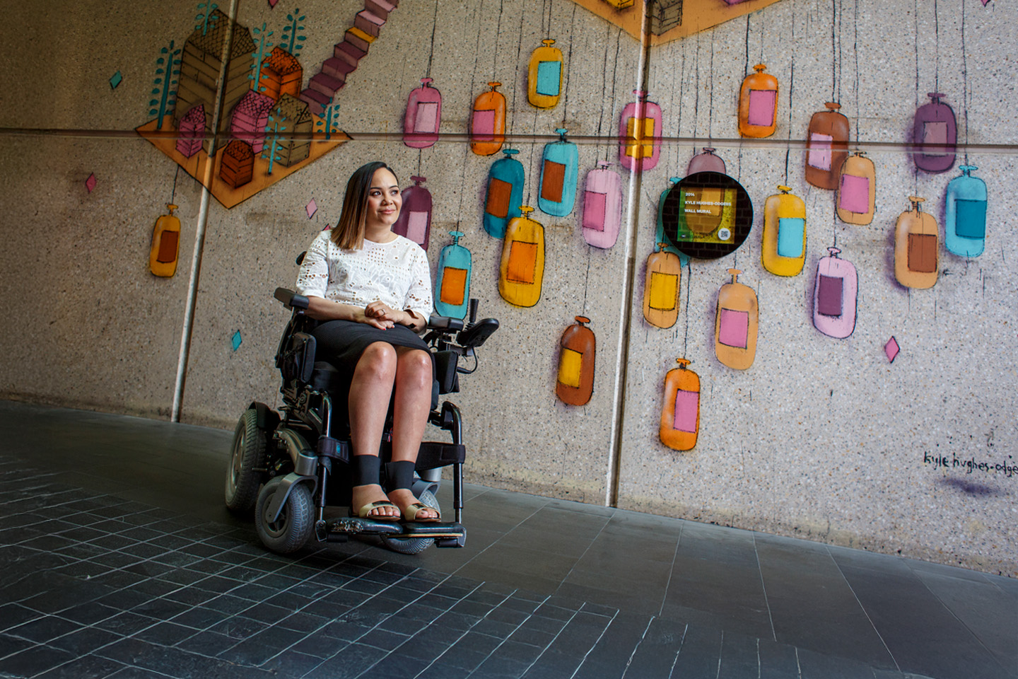 Girl in wheelchair in laneway