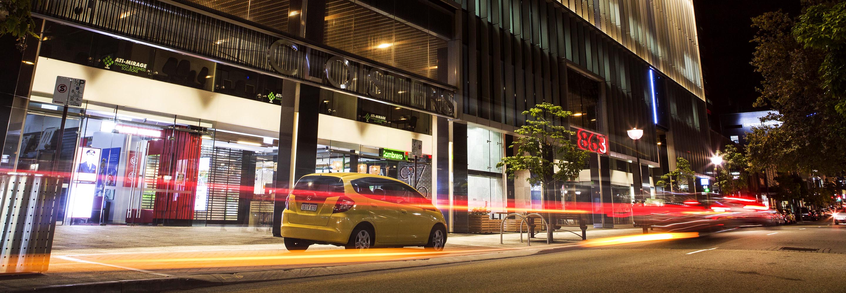 Cars parked outside shops at night