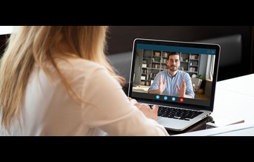 Young woman watching online course on laptop
