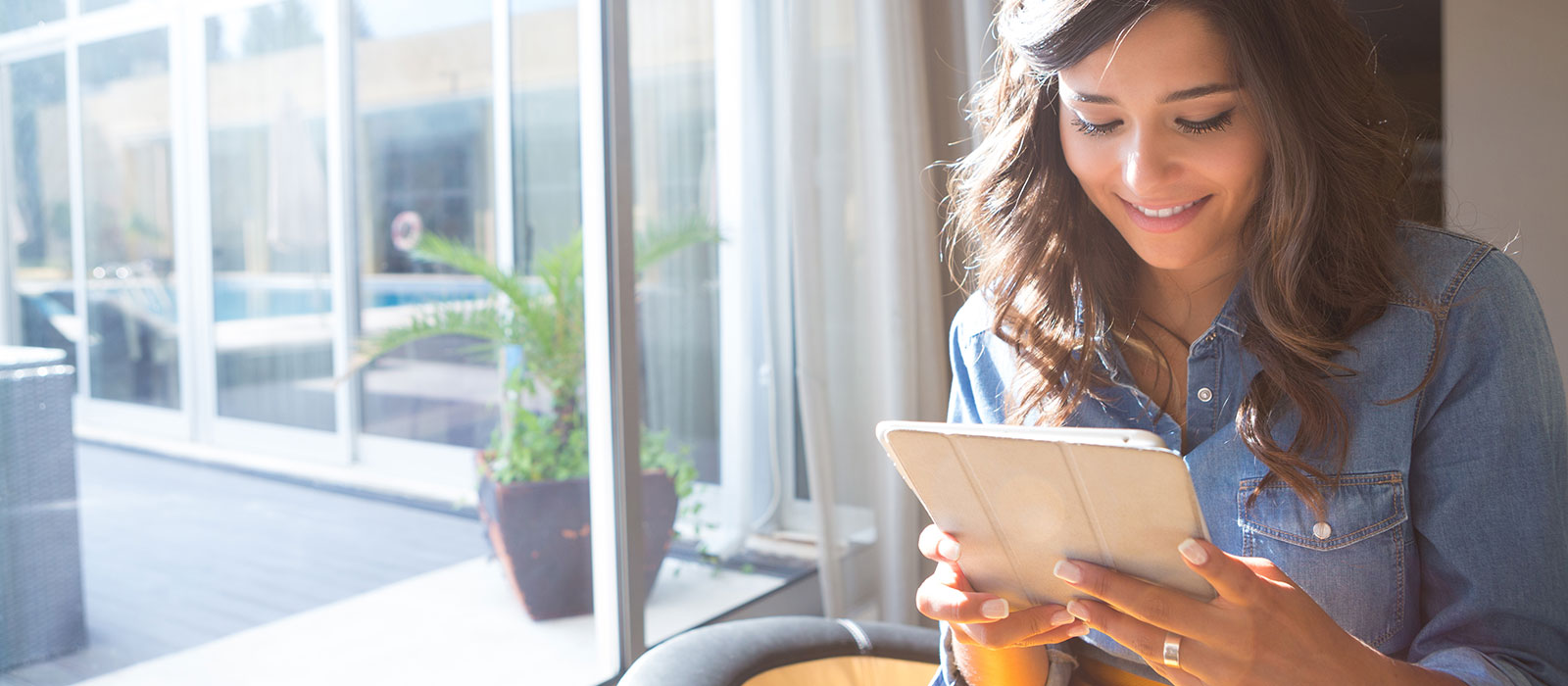 Young woman reading from tablet